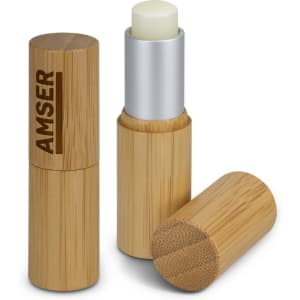 A bamboo lip balm container in natural colour with a silver top and a visible branding element.