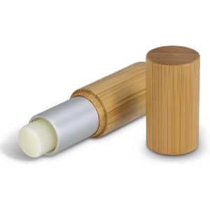 A bamboo lip balm with a silver tip and a wooden exterior, featuring a removable cap.