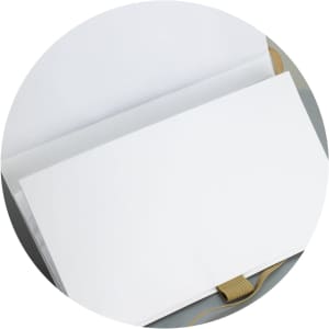 A white Beaumont Stone Paper Notebook featuring blank pages and a ribbon bookmark, with a soft cover.