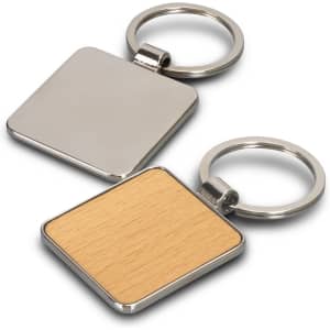 A square key ring featuring a metallic side and a light wooden side, attached to a silver keychain.