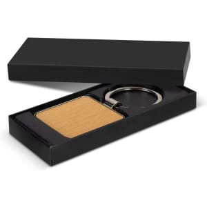 A square wooden key ring in a black gift box, featuring a metallic keyring attachment.