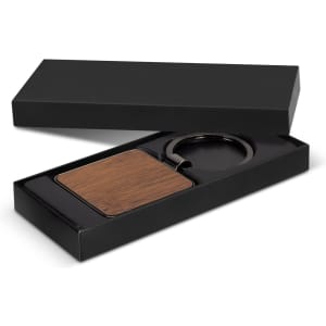 A square wooden key ring in a black gift box, featuring a sleek metal ring.