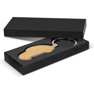 A wooden car-shaped key ring in a black gift box, featuring a metal key ring attachment.