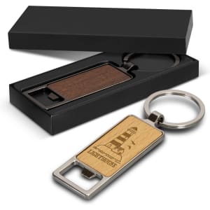 A drink bottle opener key ring in brown wood and silver metal, presented in a black box.