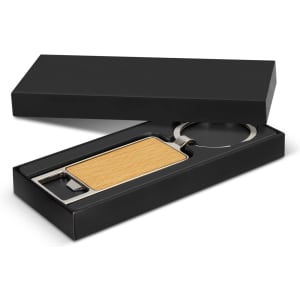 A drink bottle opener key ring with a wooden handle and silver metal features, presented in a black gift box.