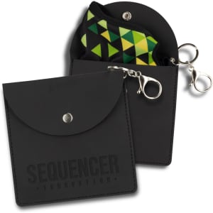 A black key ring pouch with a snap closure, featuring a colourful geometric inner pouch and a metal clip.