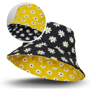 A reversible bucket hat featuring a black side with white daisies and a yellow side also decorated with daisies.