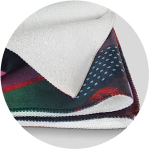 A sports fit towel featuring vibrant colours with a textured white edge and a logo. Ideal for gym use.