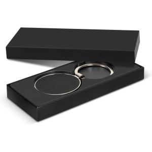 A round black key ring with a silver metal loop presented in a black box.