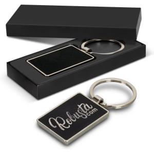 A rectangular black key ring in a sleek black box, featuring a shiny keychain attachment and a logo.