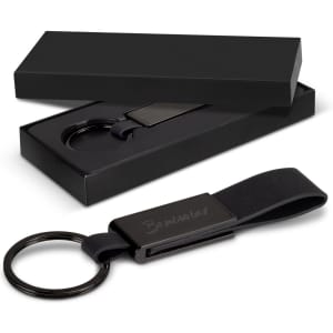 A black key ring with a sleek design, presented in an elegant black box.