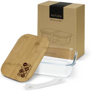 A glass lunch box with a bamboo lid and a silicone band, displayed with its packaging in a natural brown box.
