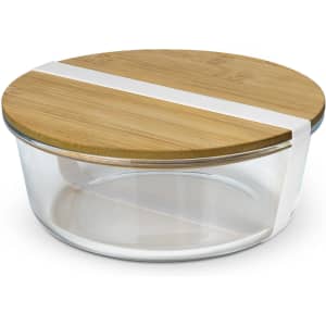 A glass food container with a bamboo lid and a white band, featuring a clear body and rounded design.