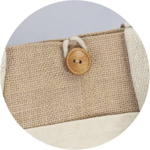 A tan jute tote bag featuring a natural wooden button and cream straps. It has a simple, eco-friendly design.