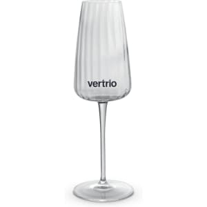 A clear, elegant flute glass with a ribbed design and a logo on the side, set against a white background.