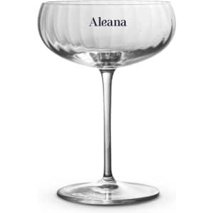 A clear cocktail glass with a textured bowl and a long stem, featuring a branding logo.