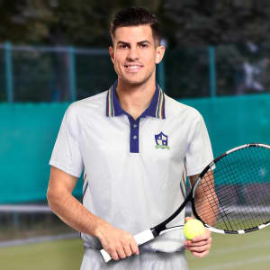 A light grey men's tennis top featuring a multi-striped collar and a logo, worn by a man holding a tennis racquet and ball.