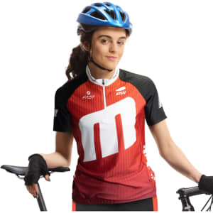 A woman wearing a red and black custom cycling top poses with a bicycle, sporting a blue helmet and black gloves.