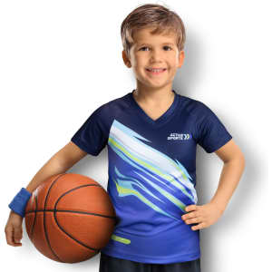 A child in a blue performance T-shirt with abstract designs, holding a basketball and wearing a wristband.