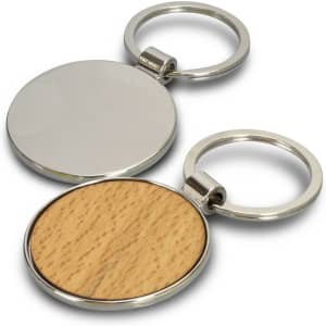 A round key ring featuring a silver metal frame with a wooden base on one side. It has a logo.