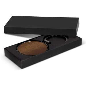 A round wooden key ring with a metal attachment, presented in a sleek black gift box.