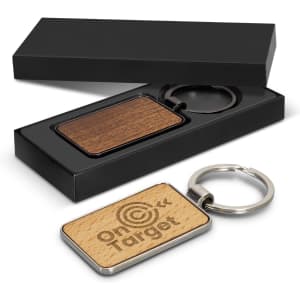 A rectangular key ring with a wooden and metal design, presented in a sleek black box.