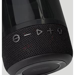 A black Bluetooth speaker with textured fabric and control buttons on the side, featuring a sleek design and a logo.