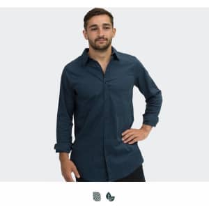 A navy blue button-up shirt worn by a man with a relaxed posture and long sleeves. The shirt features a logo.