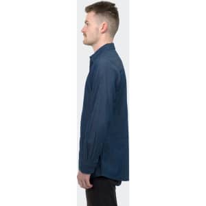 A denim button-up shirt in dark blue, featuring a collar and long sleeves, displayed on a model in profile.