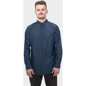 A button-up men's denim shirt in dark blue, featuring a collar and long sleeves. The shirt has a logo on it.