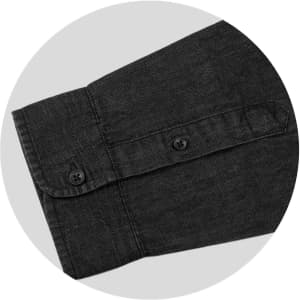A black denim shirt sleeve featuring button details, with a folded collar and a logo.