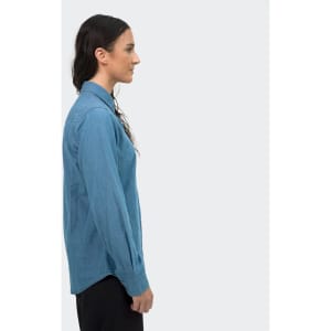 A women's denim button-up shirt in a light blue shade, displayed from the side view, featuring a collar and long sleeves.