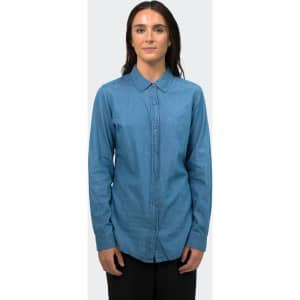 A women's button-up denim shirt in a light blue shade, featuring long sleeves and a collared neckline.