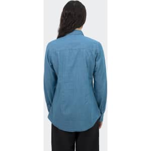 A women's denim shirt in light blue with long sleeves and a button-up design, featuring a logo on the back.