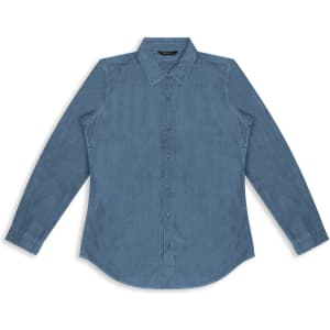 A women's button-up denim shirt in a light blue shade with long sleeves and a collar. Features a logo.