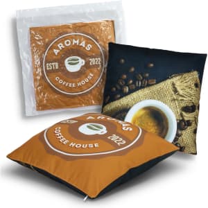 A two-sided cushion featuring an orange and black design, showcasing coffee beans and a cup, with a logo.