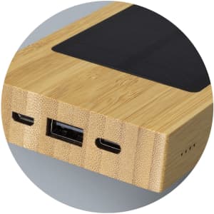 A bamboo solar power bank featuring USB and USB-C ports, with a textured surface and a sleek design.