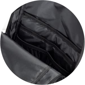 A black backpack interior featuring multiple compartments and a sleek design. It has a logo visible inside.