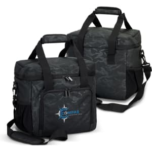 A black and grey camouflage cooler bag with shoulder straps and a front pocket. Contains a logo.