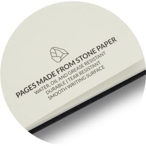 A notebook with cream pages made from stone paper, featuring a black spine and a logo.