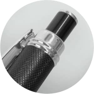 A metal Guilloche pen in black, featuring a textured grip and a silver accent. The pen has a sleek design and a logo.