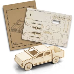 A wooden model of a UTE with assembly parts and an instruction sheet in a light brown colour.