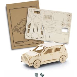 A wooden model of a hatchback car in natural colour, accompanied by an unassembled cardboard sheet with parts and details.