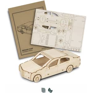A wooden model of a sedan car in a natural wood finish, accompanied by assembly instructions.