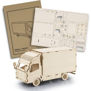 A wooden model of a small truck in natural wood colour, accompanied by a design sheet for assembly.