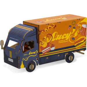 A wooden model of a small truck in blue and orange with a food truck design and a logo.