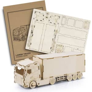 A wooden model of a large truck alongside its assembly instructions, featuring a natural wood finish.