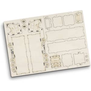 A wooden model kit featuring pre-cut pieces for constructing a large truck, displayed on a light wood board.