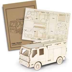 A wooden fire truck model in a light colour, accompanied by its laser-cut assembly parts and instructions.