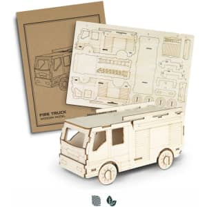 A wooden model of a fire truck, featuring detailed cut-outs and assembly instructions on a backing sheet.